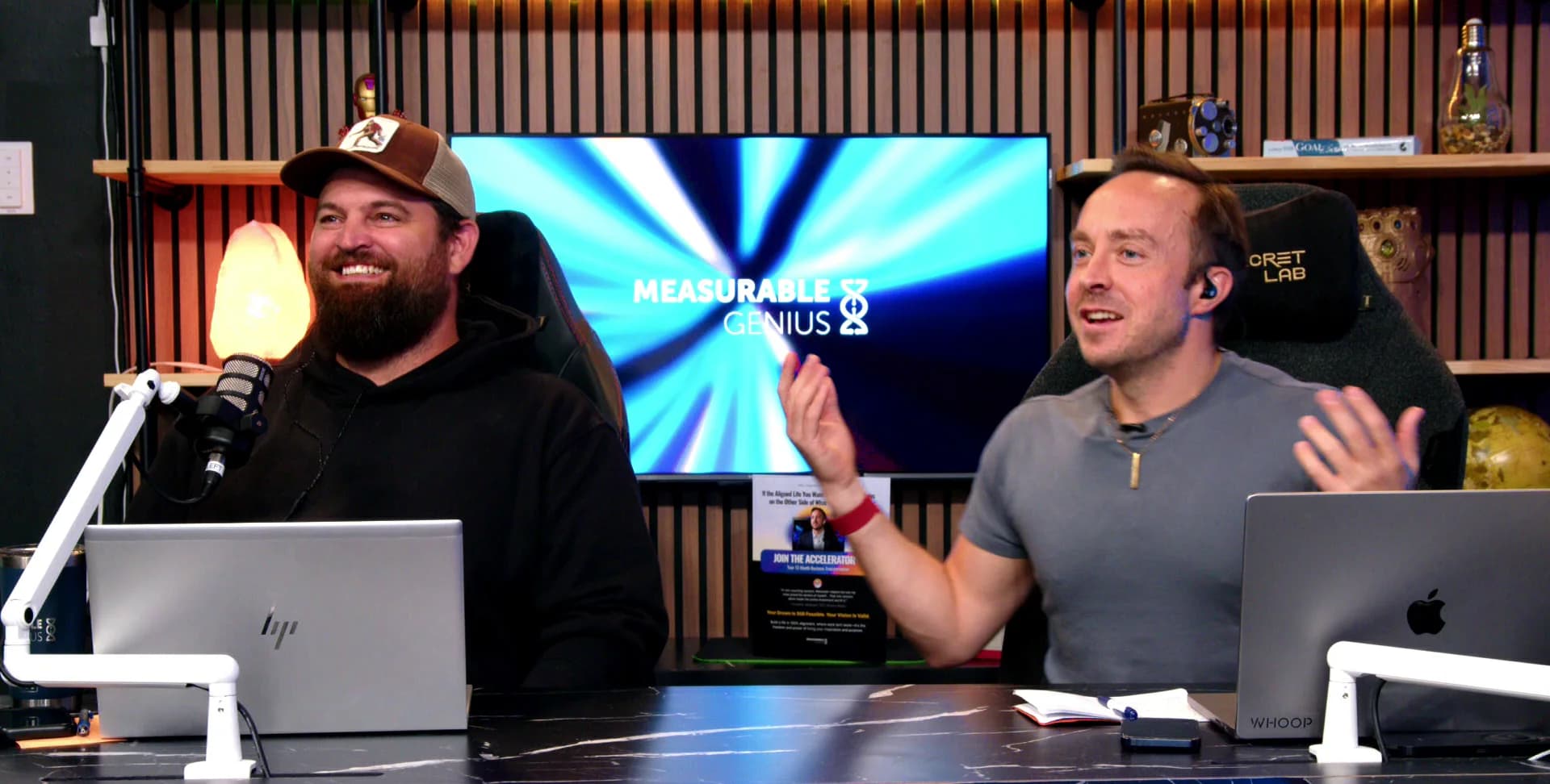 Alexander Ford and Greg Harrison Clay mid-conversation at the Measurable Genius studio desk